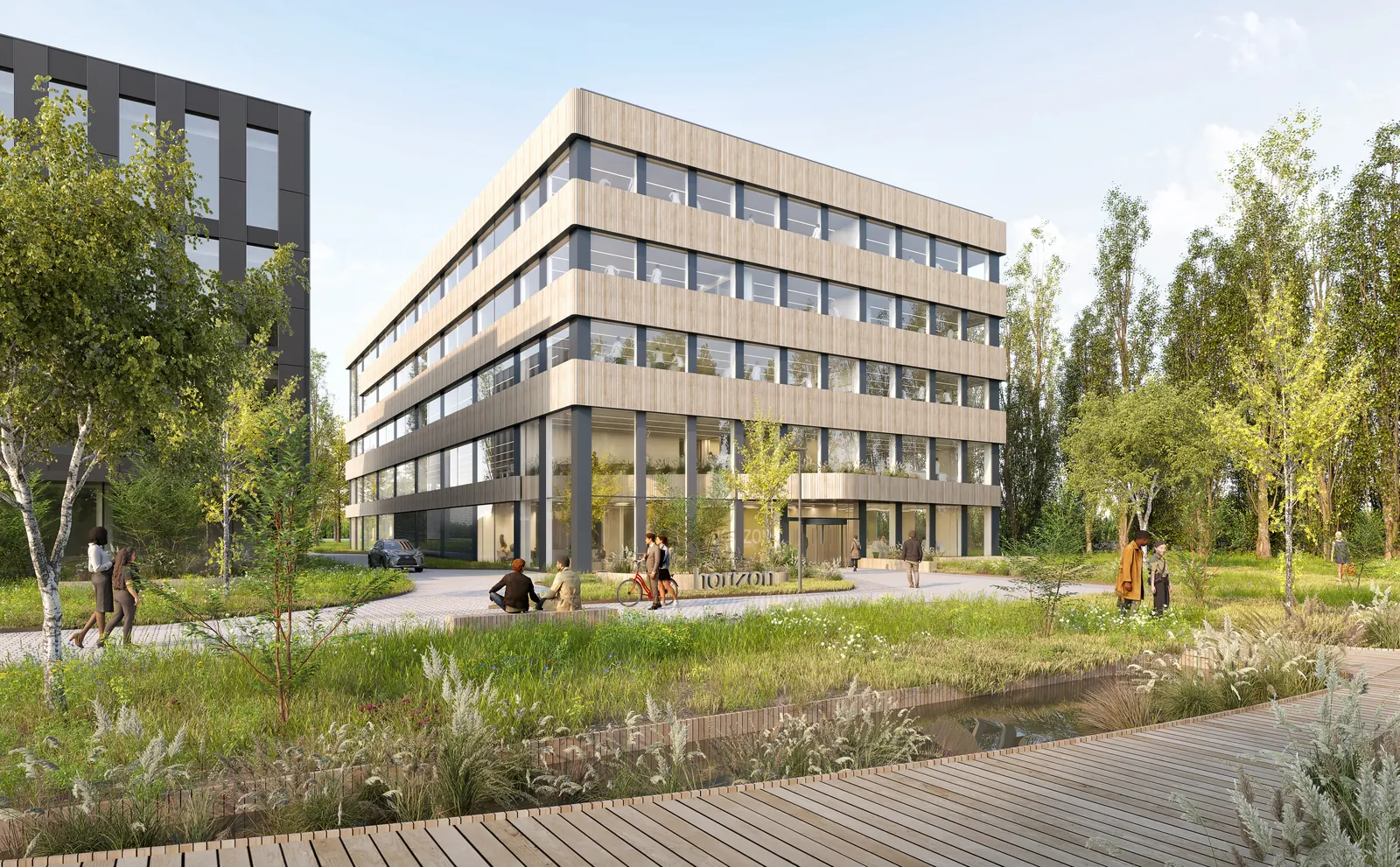 Horizon seen from the campus park: a five-storey building with timber-clad ribbons between bands of glass, surrounded by greenery.
